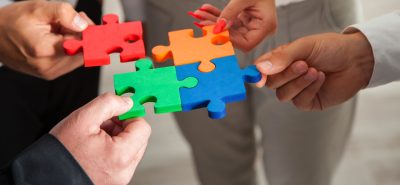 a group of people holding pieces of a puzzle.