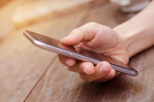 a close up of a person holding a cell phone.